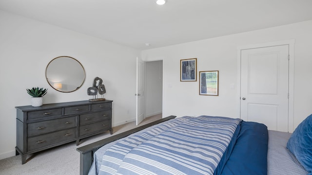 bedroom featuring baseboards and light colored carpet