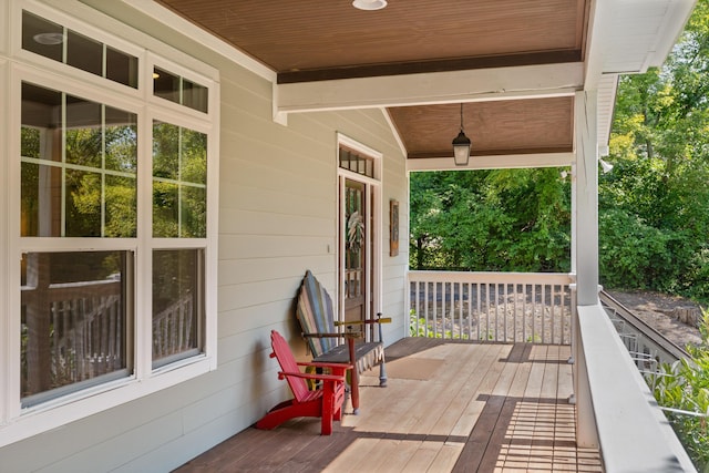 wooden terrace featuring covered porch