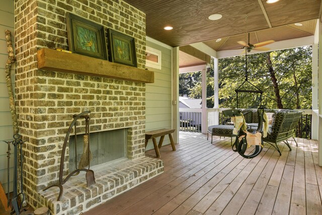 wooden deck featuring an outdoor brick fireplace