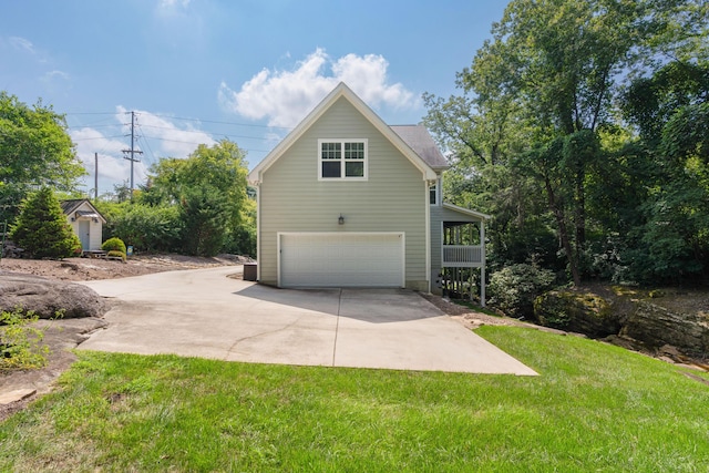 view of property exterior with driveway and a lawn