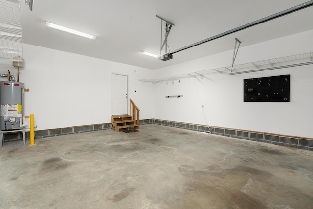 garage featuring water heater and a garage door opener