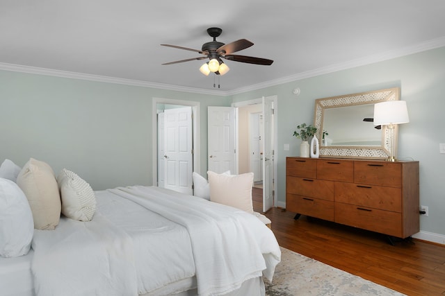 bedroom featuring ornamental molding, dark wood-style flooring, a ceiling fan, and baseboards