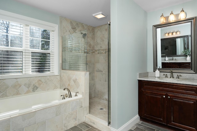 full bath with a garden tub, a tile shower, vanity, and baseboards