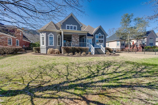 view of front of home featuring a porch, a front yard, and fence