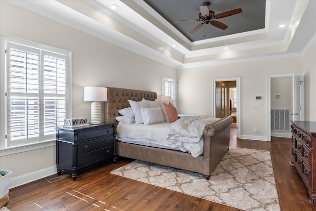 bedroom featuring baseboards, dark wood-style flooring, visible vents, and crown molding