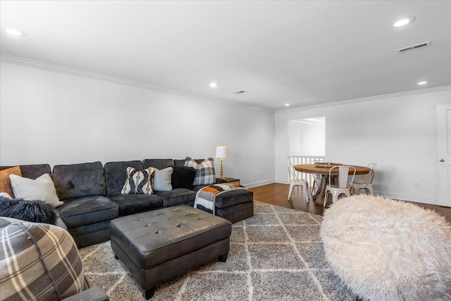 living area with visible vents, baseboards, dark wood-style floors, ornamental molding, and recessed lighting