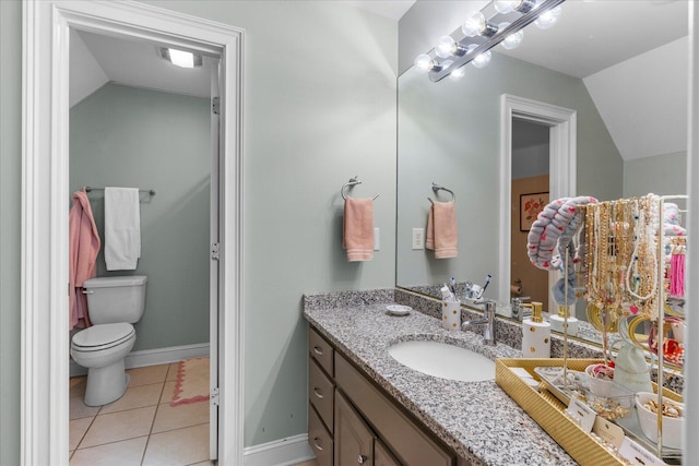 bathroom featuring baseboards, lofted ceiling, toilet, tile patterned floors, and vanity