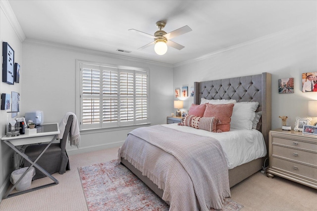 bedroom with baseboards, visible vents, light colored carpet, ceiling fan, and crown molding