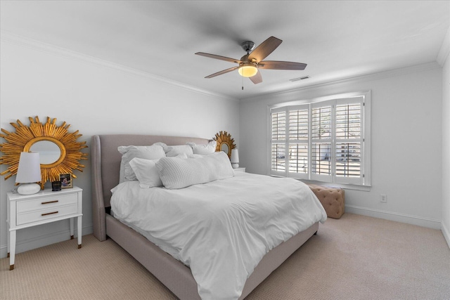 bedroom with ceiling fan, light colored carpet, visible vents, baseboards, and crown molding