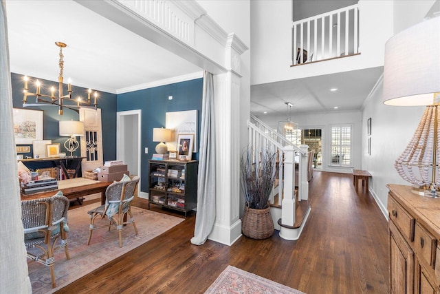 foyer featuring baseboards, stairway, ornamental molding, dark wood-type flooring, and a notable chandelier