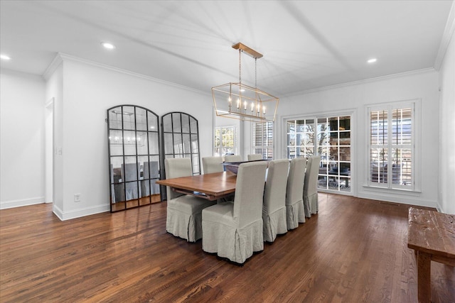 dining space with baseboards, crown molding, a chandelier, and dark wood-style flooring