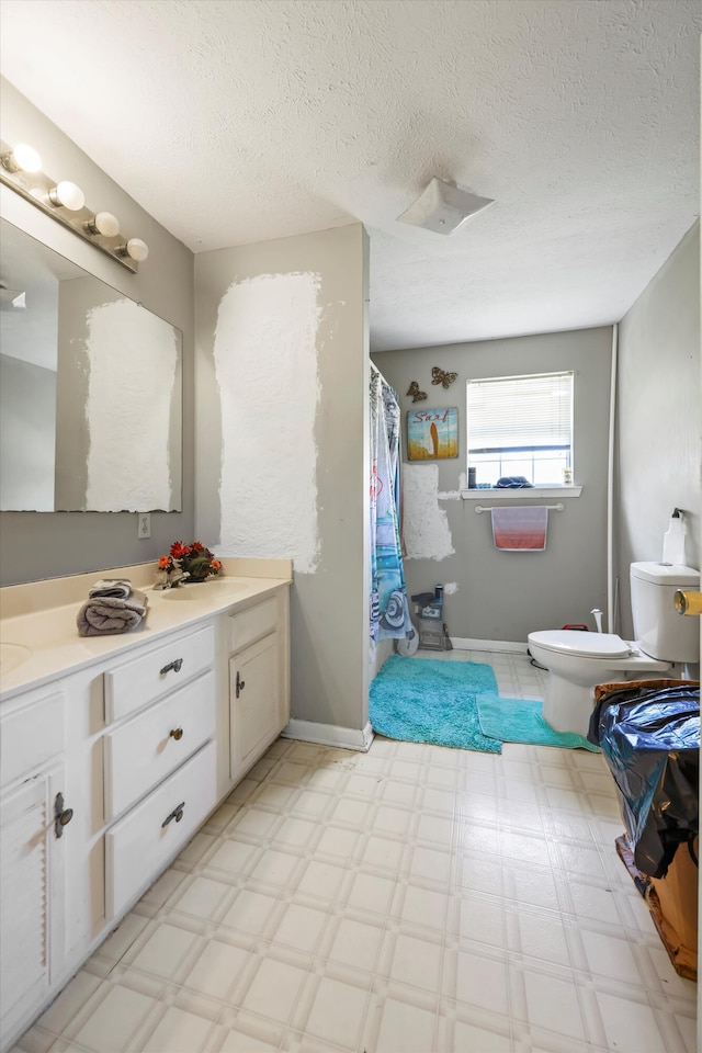 bathroom featuring a shower with curtain, vanity, toilet, and tile patterned floors