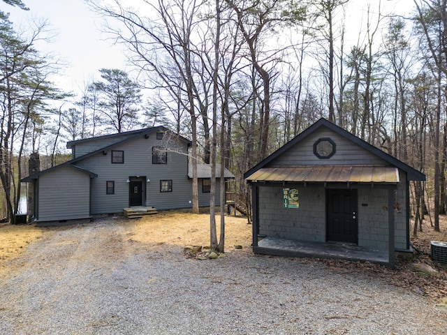 view of front of property with driveway, metal roof, and a standing seam roof