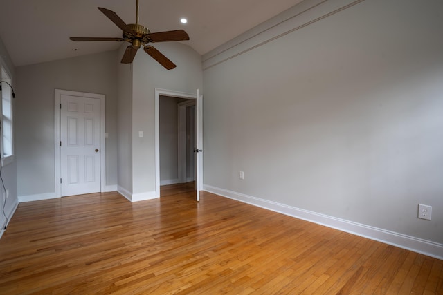 unfurnished bedroom featuring light wood finished floors, baseboards, vaulted ceiling, and recessed lighting