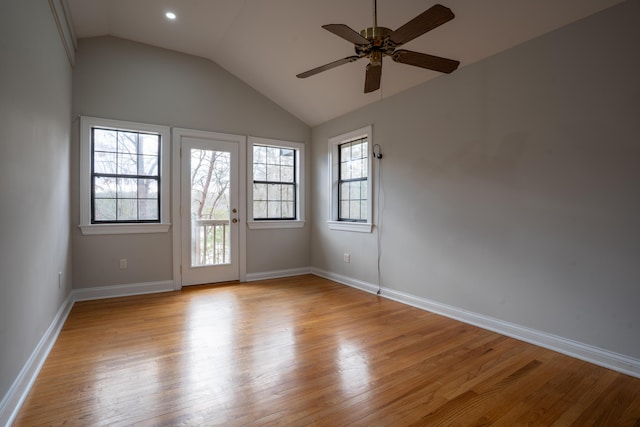 empty room with light wood-type flooring, vaulted ceiling, baseboards, and ceiling fan