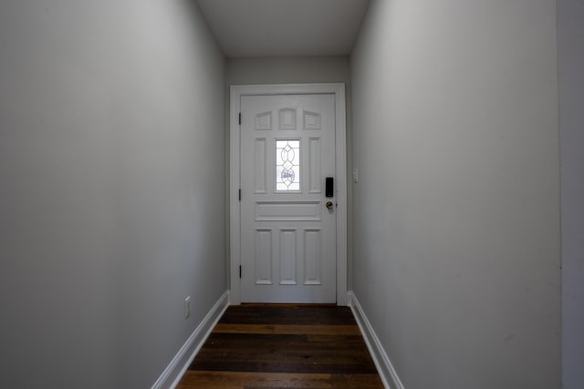 entryway featuring dark wood finished floors and baseboards