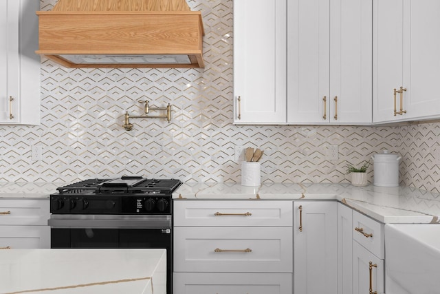 kitchen with range with gas stovetop, white cabinetry, backsplash, and custom exhaust hood