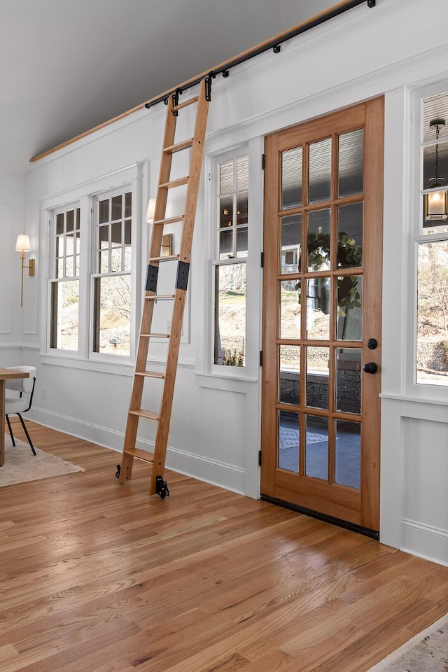 entryway featuring light wood-style floors, baseboards, and a wealth of natural light