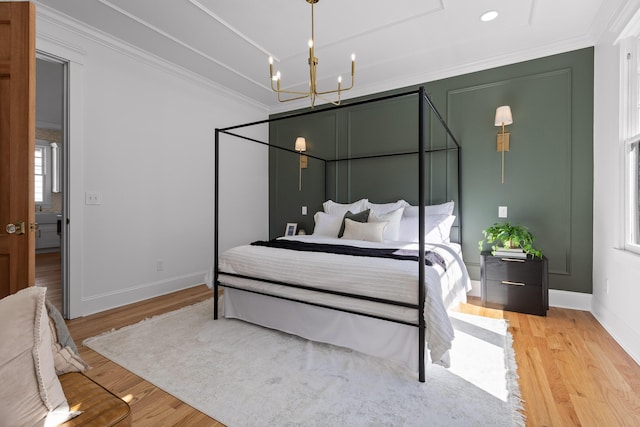 bedroom with recessed lighting, baseboards, light wood-style floors, ornamental molding, and an inviting chandelier