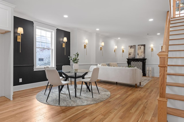 dining room with light wood-style floors, stairs, crown molding, and recessed lighting