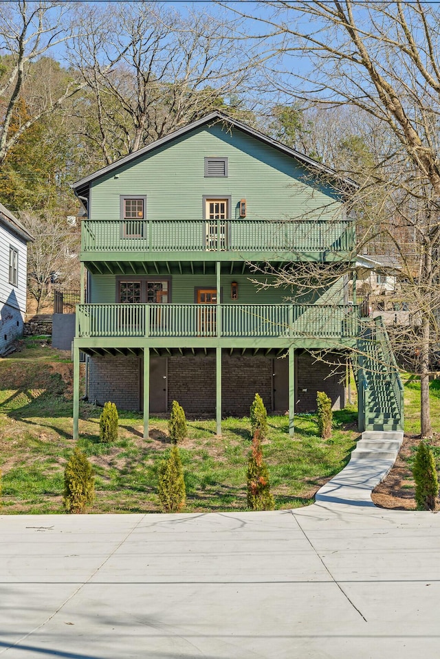 view of front of property with a wooden deck and stairs