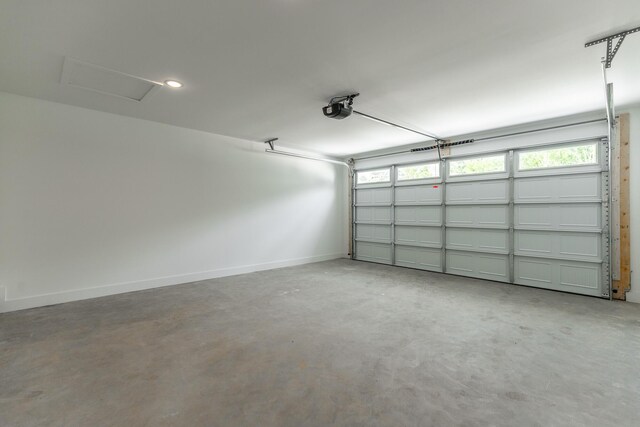 4659 Heiskell Dr, Chattanooga, TN 37416 - garage featuring a garage door opener and baseboards