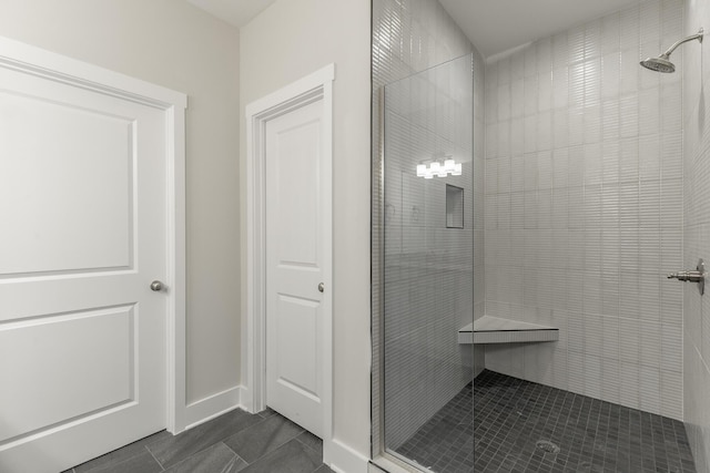 4659 Heiskell Dr, Chattanooga, TN 37416 - full bathroom featuring a tile shower, tile patterned flooring, and baseboards