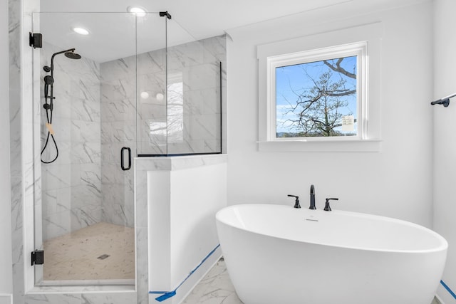 bathroom with a freestanding bath, marble finish floor, and a marble finish shower