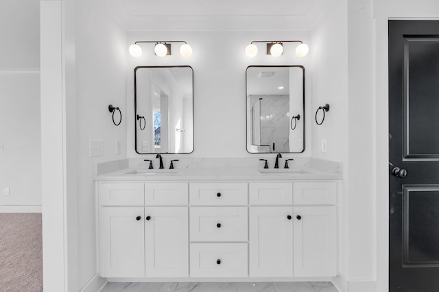 full bath featuring double vanity, marble finish floor, walk in shower, and a sink