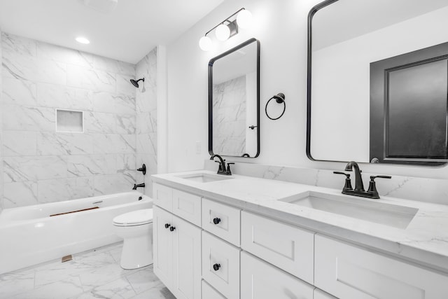 bathroom with marble finish floor, double vanity, a sink, and toilet