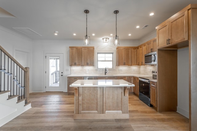 kitchen with tasteful backsplash, stainless steel microwave, electric range, light wood-style floors, and a sink