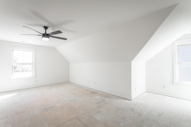 bonus room featuring a ceiling fan, vaulted ceiling, and baseboards