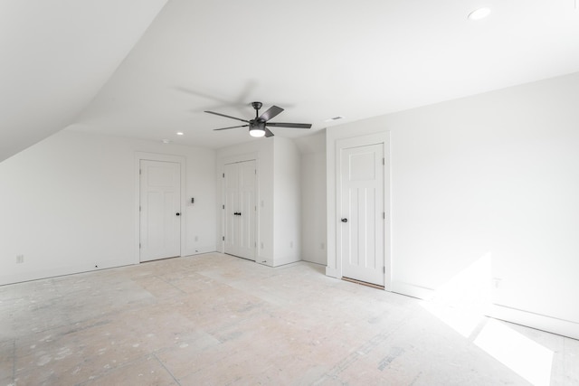 additional living space with lofted ceiling, visible vents, and ceiling fan