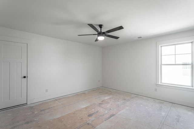 unfurnished room featuring ceiling fan, visible vents, and baseboards