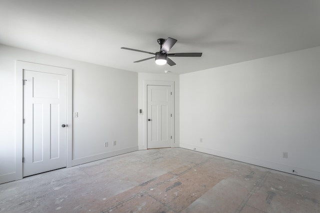 unfurnished room with ceiling fan and baseboards