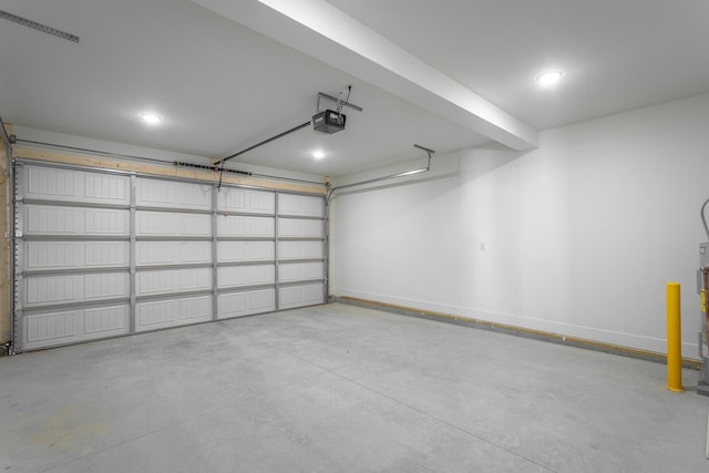 garage with baseboards and a garage door opener