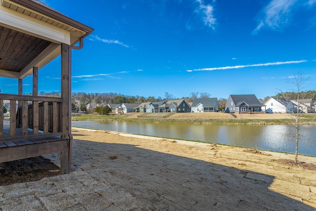 view of yard featuring a water view and a residential view