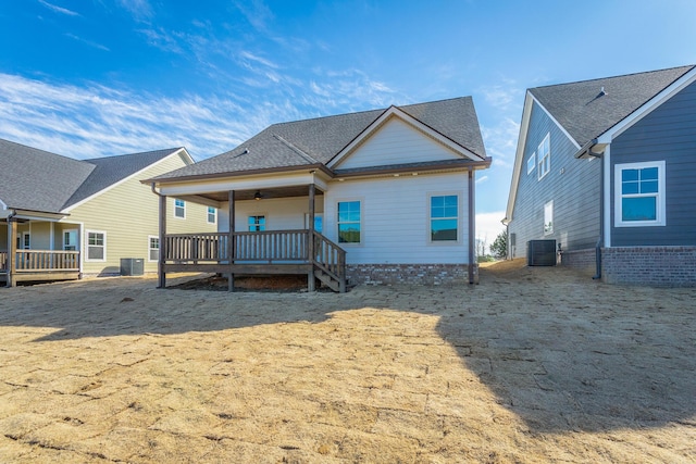 rear view of property featuring central air condition unit and a wooden deck