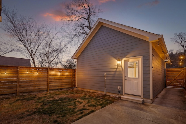 view of outbuilding featuring a gate and fence