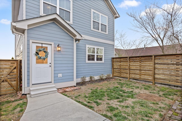 doorway to property featuring fence