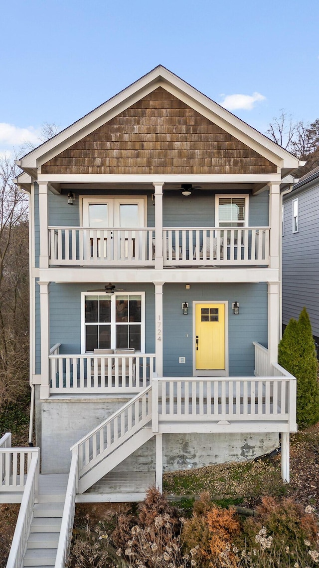 view of front facade with a balcony, stairs, and a porch