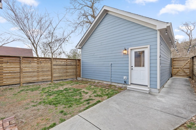 rear view of house with a patio and a fenced backyard