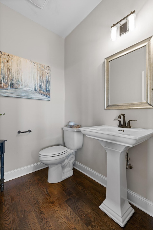 bathroom featuring wood finished floors, toilet, and baseboards