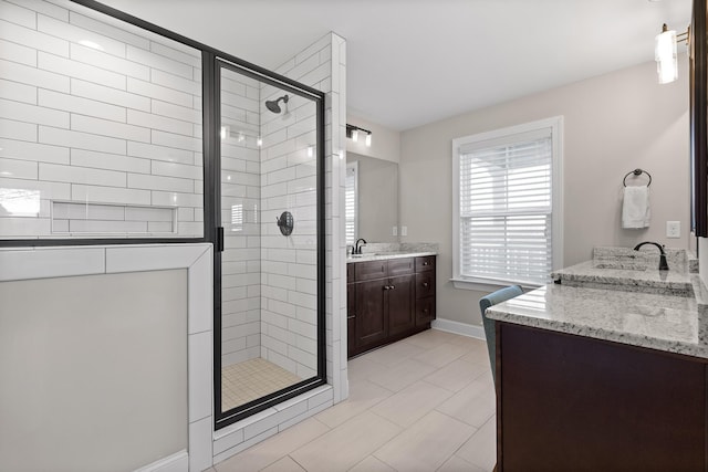 bathroom with a sink, two vanities, and a shower stall