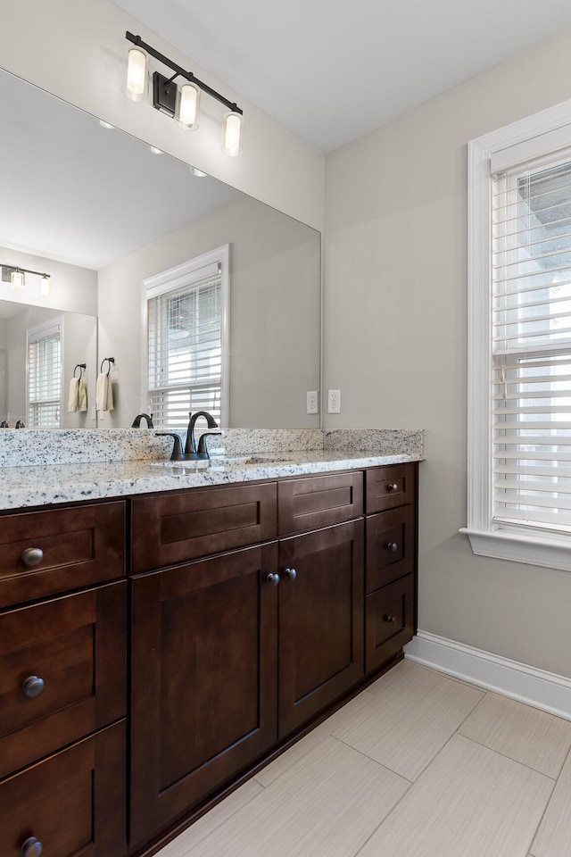 bathroom featuring baseboards and vanity