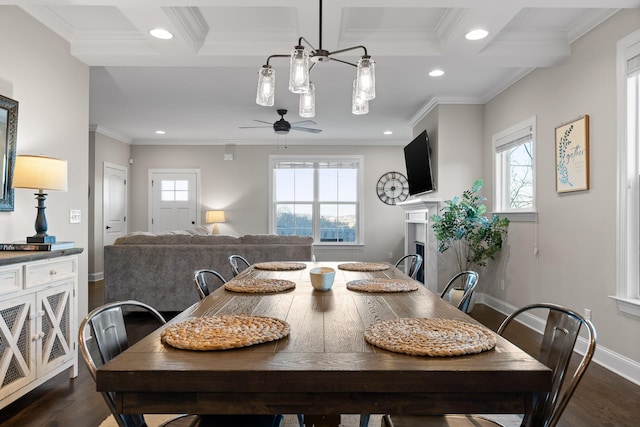 dining room featuring dark wood-type flooring, recessed lighting, crown molding, and a fireplace