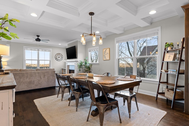 dining area with a healthy amount of sunlight, a fireplace, coffered ceiling, and beam ceiling