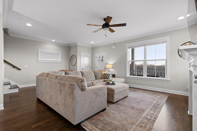 living area featuring dark wood-style floors, stairs, baseboards, and crown molding