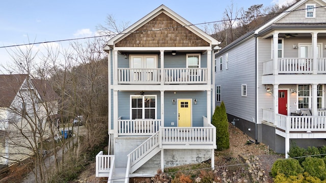 view of front of property with covered porch, a balcony, and a ceiling fan