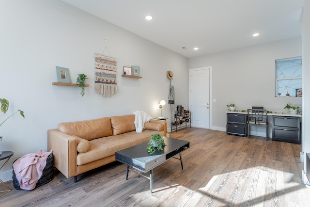 living area featuring baseboards, wood finished floors, and recessed lighting